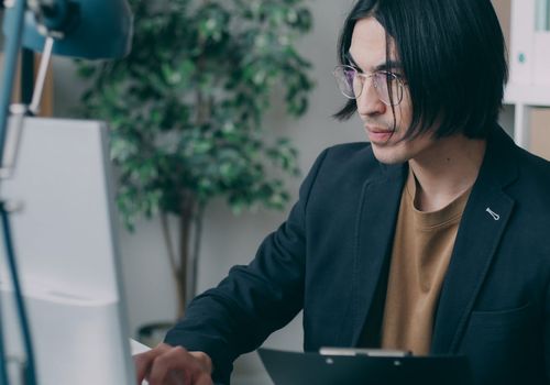 Person working at a computer with good posture